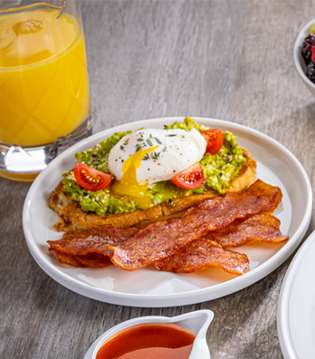 Fresh breakfast plate of avocado toast and Al Fresco Fully Cooked Chicken Bacon