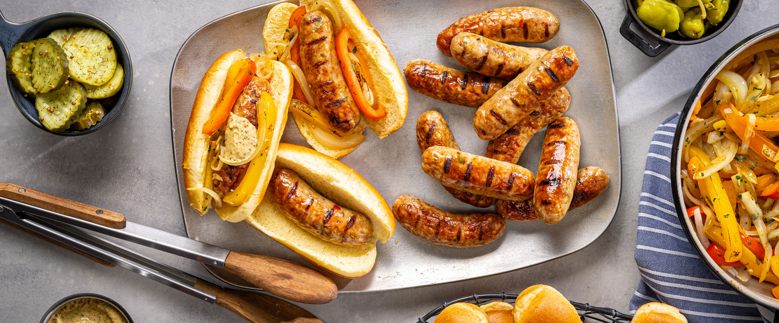 Perfectly grilled Al Fresco chicken sausage on a plate with fresh ingredients on a table