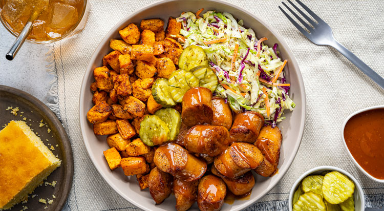 A fresh barbeque Al Fresco chicken sausage bowl with pickles slaw and sweet potato