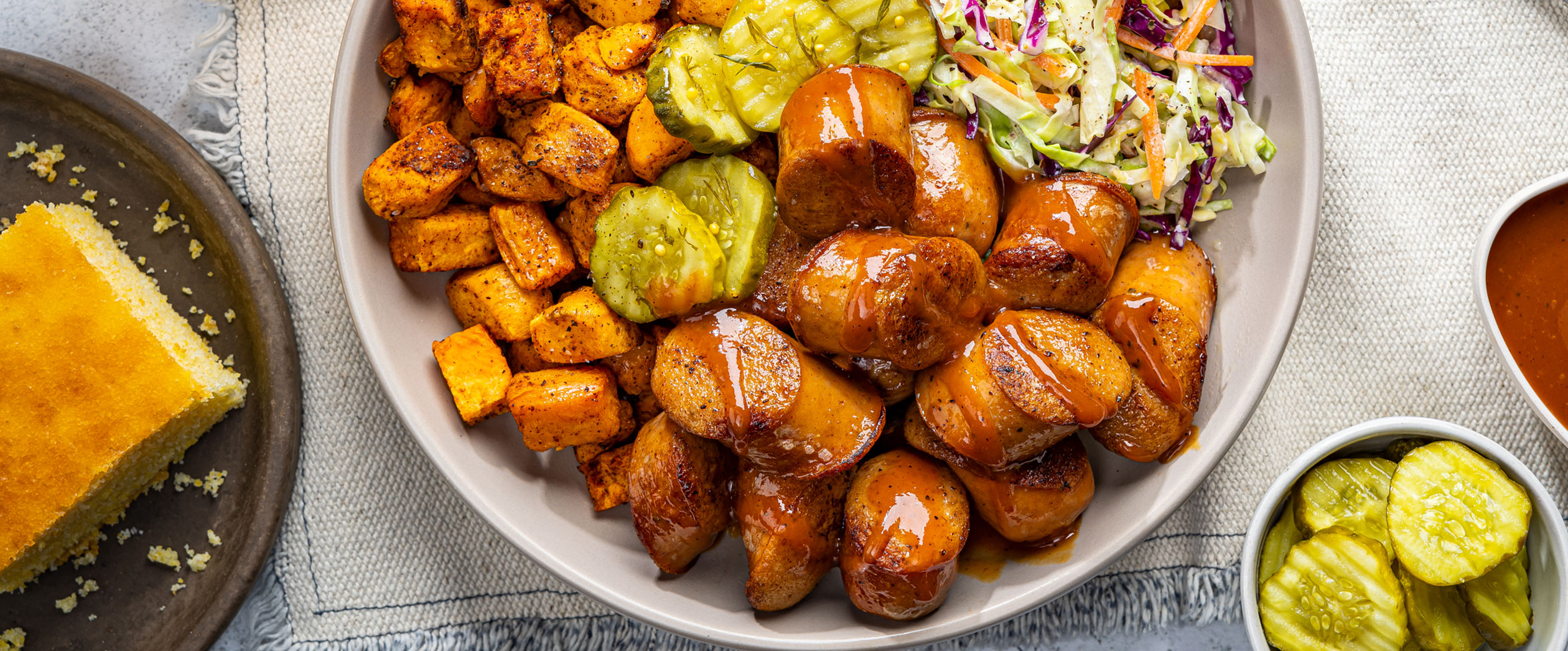 A fresh barbeque Al Fresco chicken sausage bowl with pickles slaw and sweet potato