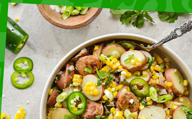 A bowl of spicy corn chowder salad with Al Fresco Jalapeno Chicken Sausage and fresh ingredients