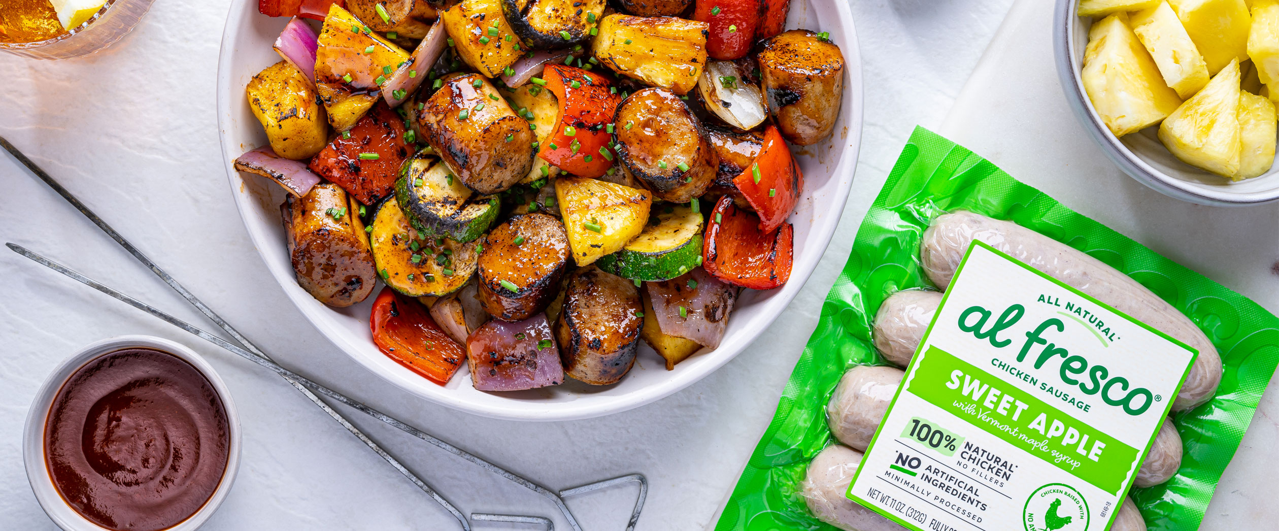 A bowl of freshly grilled Al Fresco Apple Chicken Sausage with fresh vegetables