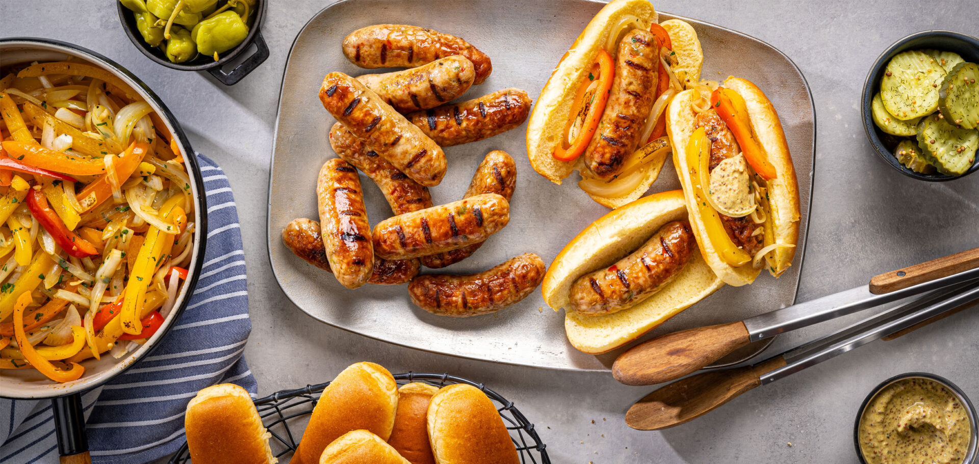 Freshly grilled Al Fresco chicken sausage on a plate and in a bun