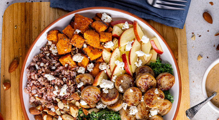 Fresh bowl of apple, kale, sweet potato, and Al Fresco Apple Chicken Sausage