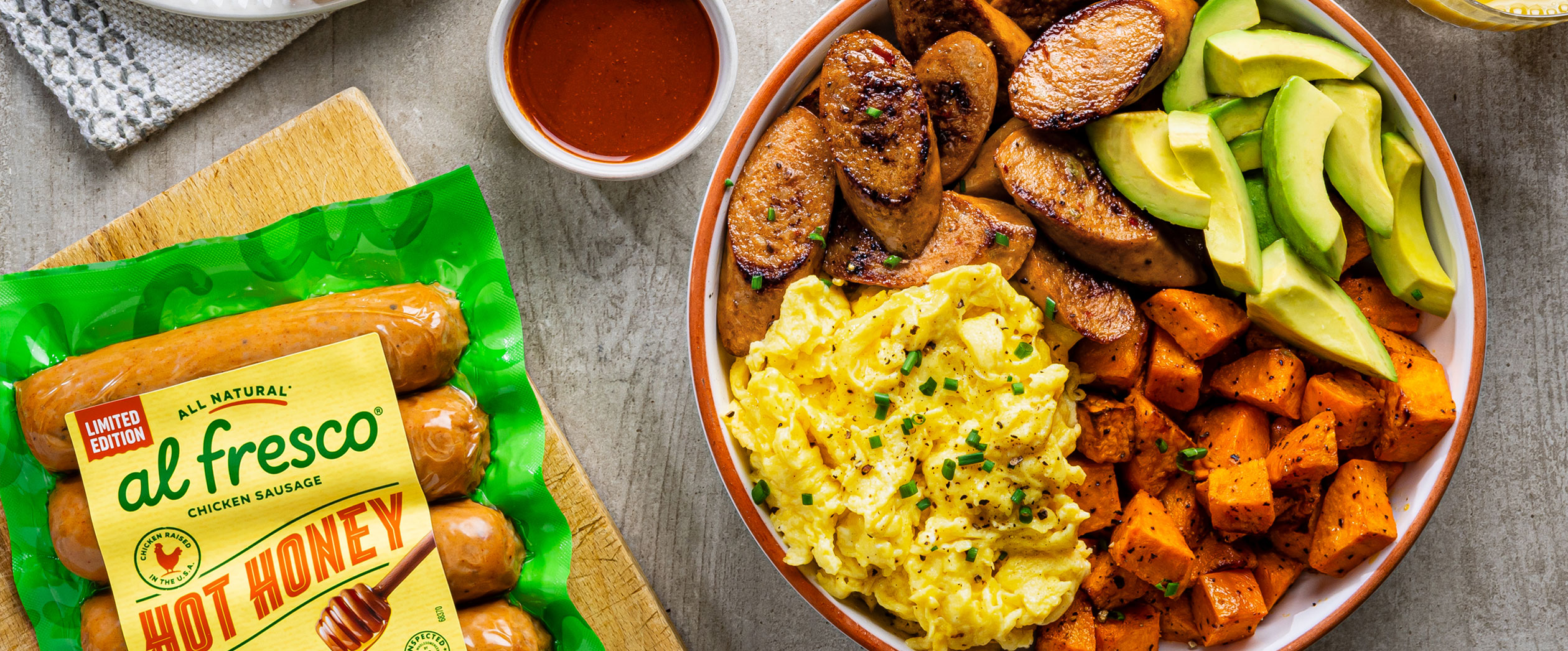 Al Fresco Hot Honey Chicken Sausage in protein bowl with eggs and sweet potato and avocado