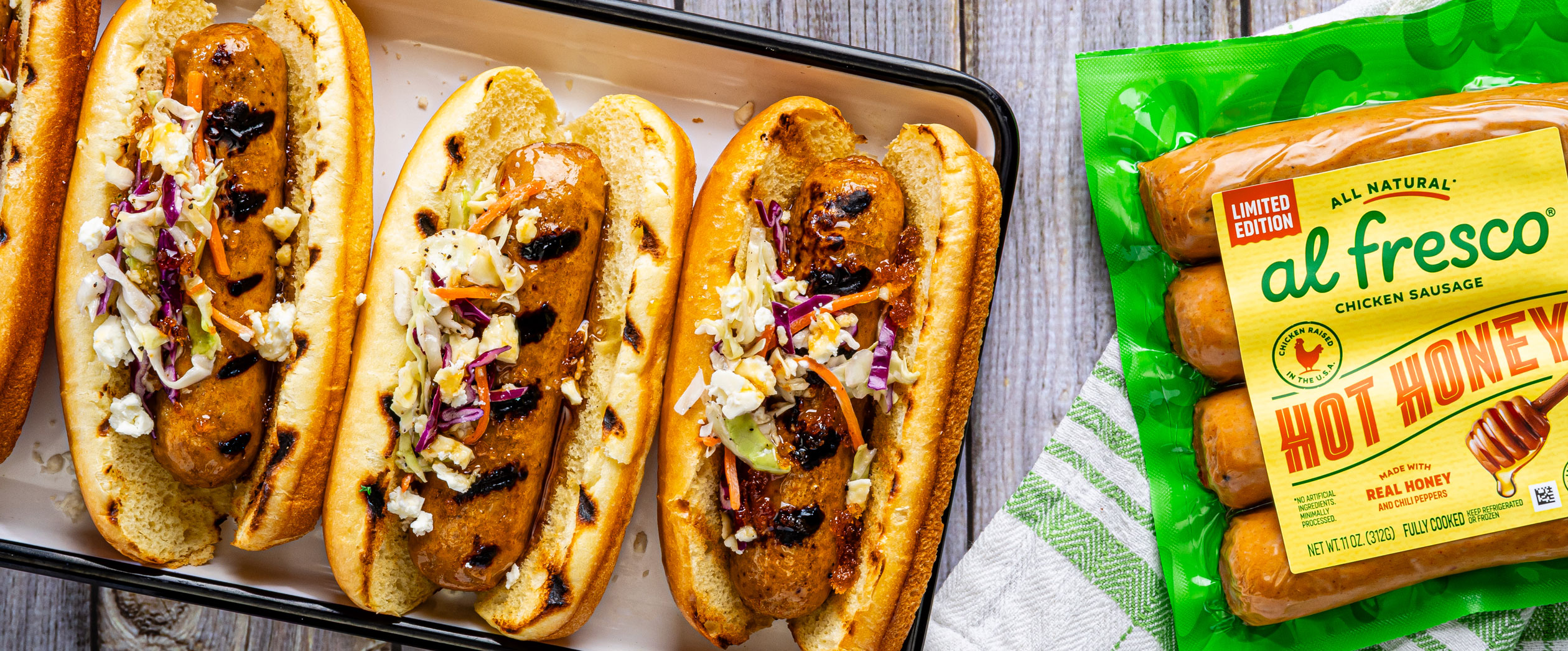 Al Fresco Hot Honey Chicken Sausage in a bun with summer slaw